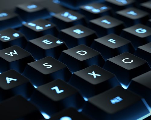 Backlit keyboard close up. Black keys with illuminated character